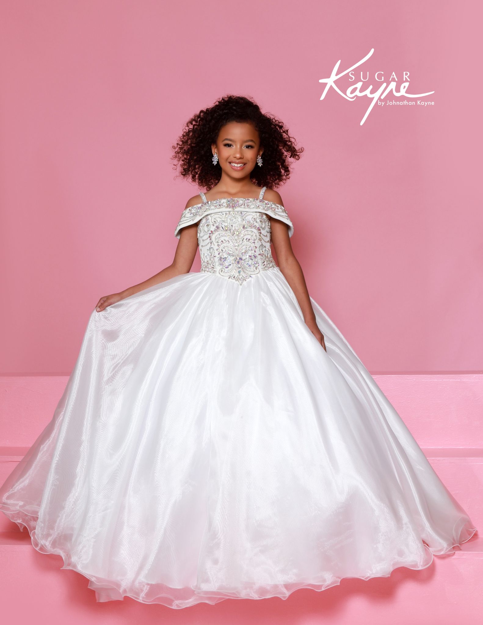 White kids ballgown with off-the-shoulder straps and sparkly bodice, stunning choice for pageants and flower girl moments.